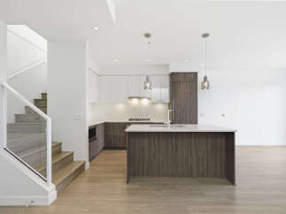 This stunning modern kitchen features sleek cabinetry, a spacious island, and high-end appliances.