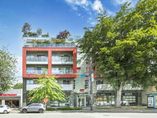 Discover modern living at this stunning property! This building boasts a contemporary design with a vibrant red facade and a rooftop garden, offering a unique urban oasis.