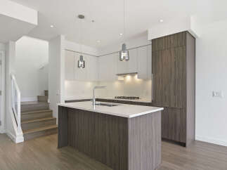 This modern kitchen boasts sleek cabinetry and a spacious island, perfect for both cooking and entertaining.
