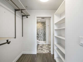 Step into luxury with this stunning walk-in closet, offering ample storage and organization.