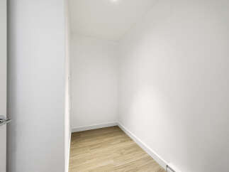 Step into this bright and airy closet, perfect for organizing your wardrobe.