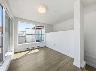 Step into this bright and airy space, featuring expansive windows that flood the room with natural light.