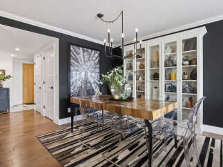 This stunning dining room showcases a modern aesthetic with its sleek design and elegant features.