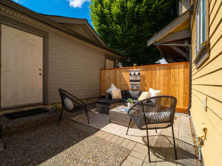 Enjoy outdoor living in this charming patio space! This property features a cozy seating area, perfect for relaxing or entertaining guests.