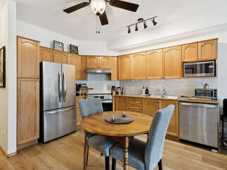 This charming kitchen boasts warm wooden cabinetry, creating a welcoming atmosphere.