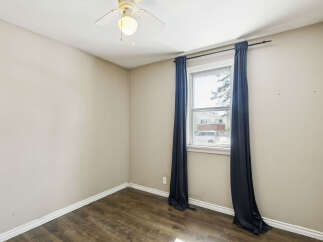 This cozy room features a neutral color palette, creating a versatile space ready for your personal touch.