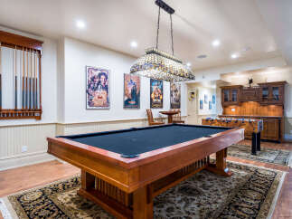 Step into luxury with this stunning game room, perfect for entertaining and relaxation.