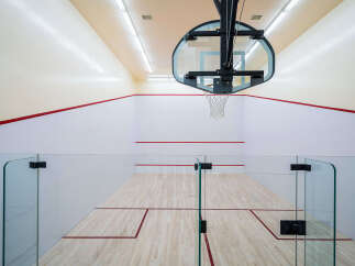Step into a state-of-the-art squash court, perfect for fitness enthusiasts and competitive players alike.