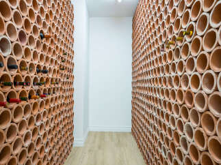 Discover the perfect blend of functionality and style with this unique wine cellar design.