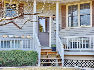 This charming home features a welcoming front porch and a well-maintained exterior.