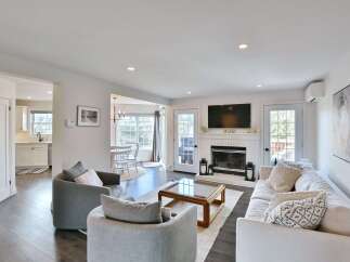 Step into this inviting living space, featuring a cozy fireplace and a modern aesthetic.