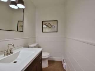 This stylish powder room features a modern vanity with a sleek sink and faucet.