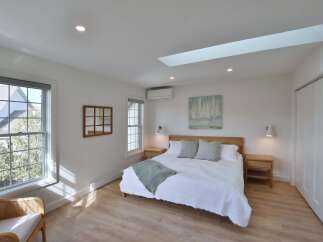 This stunning bedroom offers a serene retreat with its bright and airy ambiance.