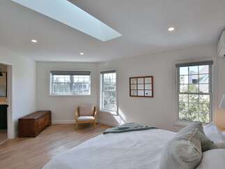 This stunning bedroom boasts a bright and airy atmosphere, perfect for relaxation.