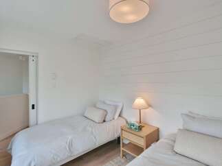 This cozy bedroom features two twin beds, perfect for guests or a shared living space.