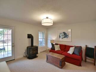 This cozy living space features a striking red sofa, perfect for relaxing.