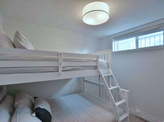 This charming bedroom features a cozy bunk bed, perfect for accommodating guests or creating a fun space for kids.