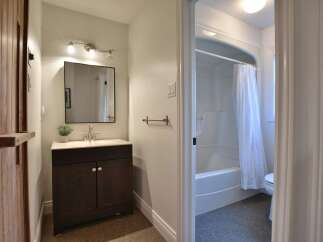 This charming bathroom features a stylish vanity with ample storage, perfect for keeping essentials organized.