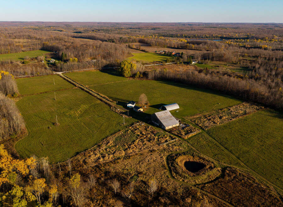 Discover this expansive rural property featuring a charming farmhouse and a large barn, perfect for agricultural pursuits or a private retreat.