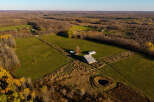 Discover this expansive rural property featuring a charming farmhouse and a large barn, perfect for agricultural pursuits or a private retreat.