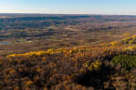 Experience the beauty of autumn from this elevated vantage point, showcasing rolling hills adorned with vibrant fall foliage.