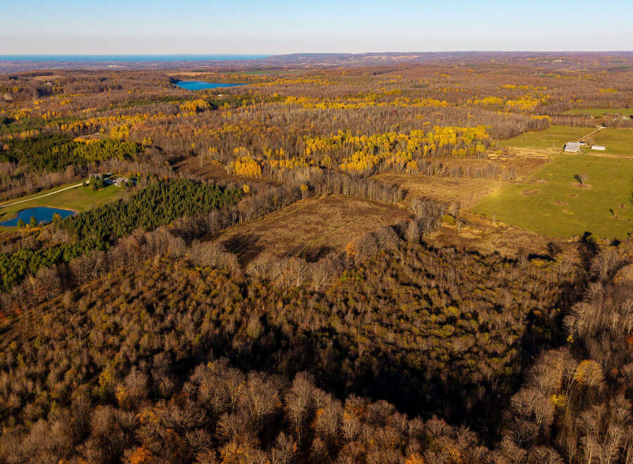 Discover this stunning aerial view of a sprawling rural landscape, perfect for those seeking tranquility and nature.