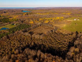 Discover this stunning aerial view of a sprawling rural landscape, perfect for those seeking tranquility and nature.