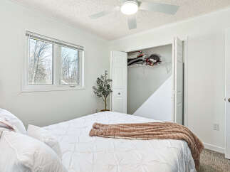 This bright and airy bedroom offers a serene retreat with its crisp white walls and ample natural light.
