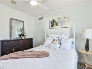 Step into a serene bedroom retreat, where comfort meets elegance.