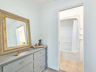 This charming bathroom features a stylish vanity with a large mirror, perfect for getting ready.