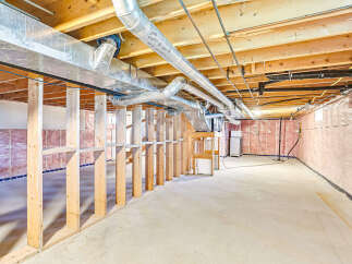 Explore the potential of this unfinished basement, perfect for customization.