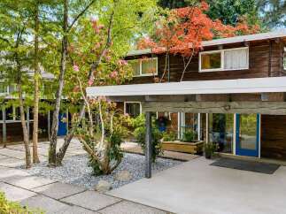 Discover this stunning property featuring a unique architectural design and lush landscaping.