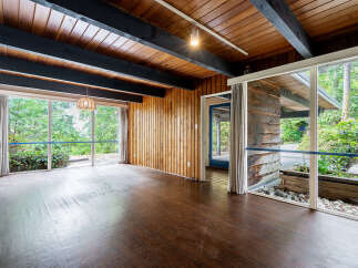 Step into this stunning mid-century modern home, showcasing a seamless blend of natural elements and architectural design.