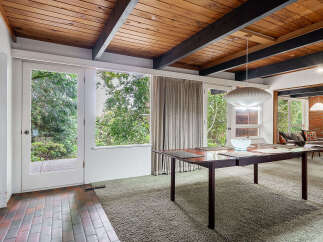 Step into this stunning home featuring a mid-century modern design.