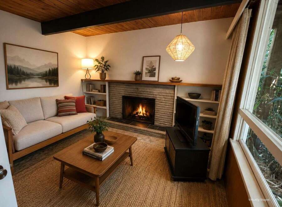 Cozy living room featuring a natural wood ceiling and a stone fireplace, perfect for relaxing evenings.