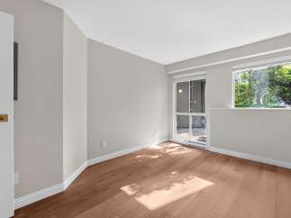 Step into this bright and airy room, featuring beautiful hardwood floors and neutral walls, creating a versatile space.
