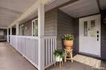 Welcome guests to this charming home with a covered front porch, perfect for enjoying your morning coffee.