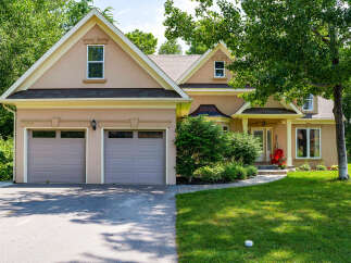 This stunning property boasts a beautiful exterior with a well-maintained lawn and lush landscaping.