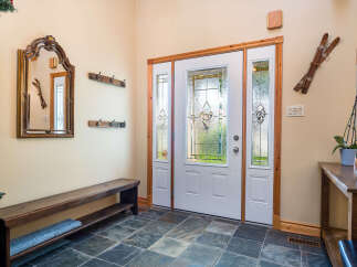 Step into this inviting entryway, showcasing a blend of rustic charm and modern elegance.