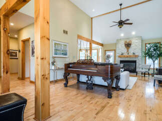 This stunning property boasts a spacious living area with a grand piano, perfect for entertaining or relaxing.