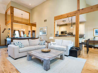 Step into luxury with this stunning living space, featuring soaring ceilings and an open-concept design.