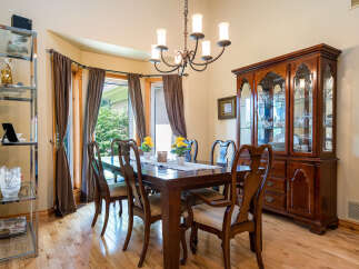 This elegant dining room features a beautiful wooden dining table with seating for six, perfect for hosting dinner parties.