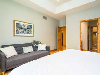 Step into this inviting bedroom, featuring a cozy sofa perfect for relaxation.