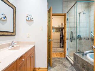 Step into luxury with this stunning bathroom featuring a spacious walk-in shower and a relaxing bathtub.