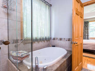 This luxurious bathroom features a relaxing jacuzzi tub, perfect for unwinding after a long day.