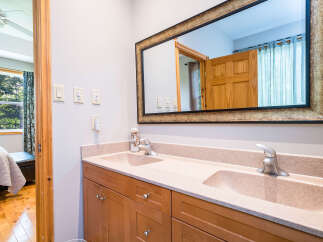 This stunning bathroom boasts a double vanity with a sleek design, perfect for a modern home.