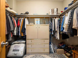 Step into this well-organized walk-in closet, a dream space for any homeowner.