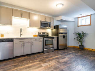 This stunning kitchen boasts modern appliances and ample cabinet space, perfect for culinary enthusiasts.