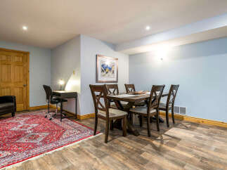 This inviting dining area features a stylish wooden table and chairs, perfect for family meals or entertaining guests.