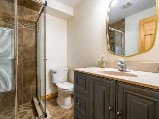 Step into this beautifully designed bathroom, featuring a modern vanity with ample storage and a stylish sink.